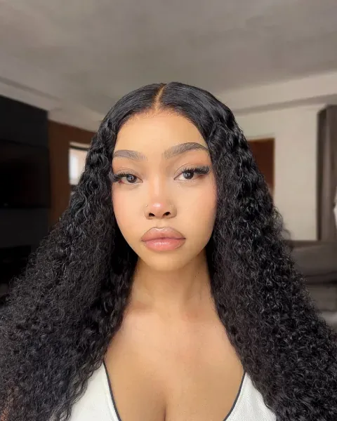 A curly lace-front wig worn long